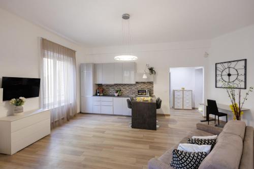 a living room with a couch and a kitchen at Genoa Lux Apartments with parking in Genova