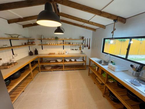 a kitchen with wooden shelves and a large window at Casa de Campo para desconectarse de la ciudad in Rancagua
