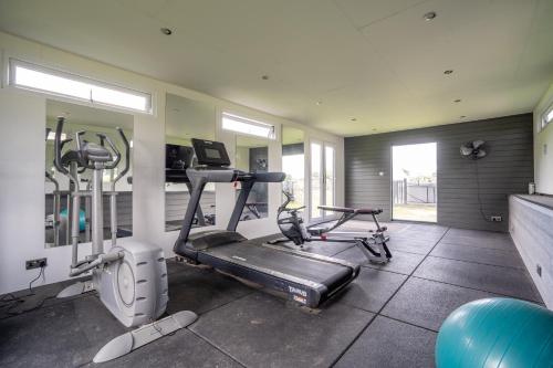 a gym with two exercise bikes and a treadmill at Barn Cottage - North East Escapes in Bamburgh