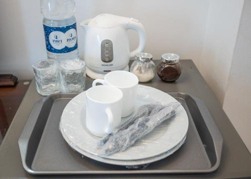 a tray with two plates and cups and a blender at Villa Mosta in Mosta