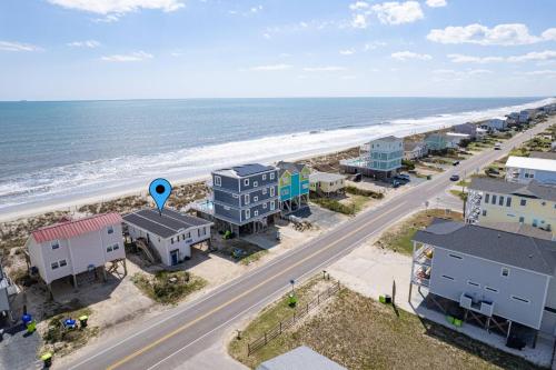 an aerial view of a beach with houses and the ocean at Somewhere on a Beach in Oak Island