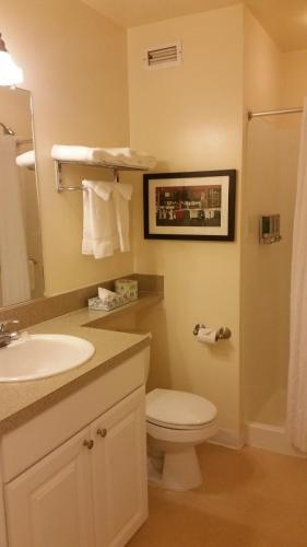 a bathroom with a white toilet and a sink at Washington Plaza - Portland in Portland