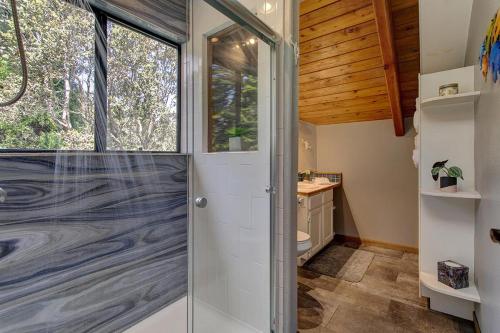 a bathroom with a shower and a glass door at Halehikiola in Volcano