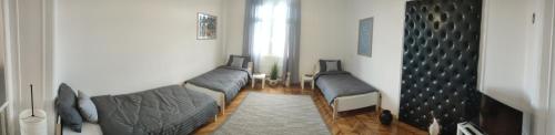 a living room with two beds in a room at Vuk 1 in Belgrade