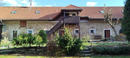 a large stone house with a red roof at Statek Kloubek in Chabičovice