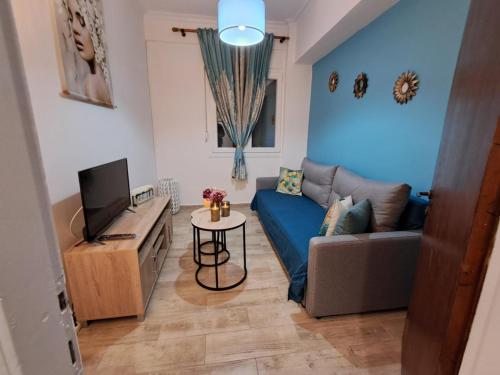 a living room with a couch and a tv at Filitsa's house in Vathý
