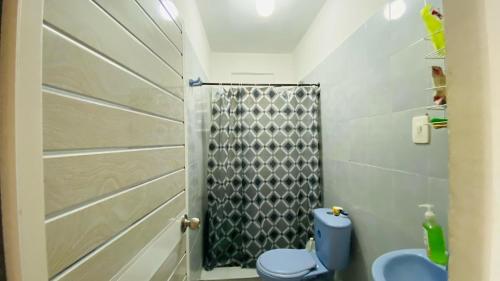 a bathroom with a blue toilet and a shower at Rincon Samario in Santa Marta