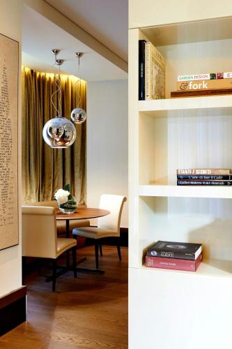a kitchen and a dining room with a table at Excelsior Hotel Gallia, a Luxury Collection Hotel, Milan in Milan