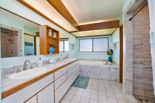 a bathroom with two sinks and a tub at Pu'u Nui in Waikoloa Village
