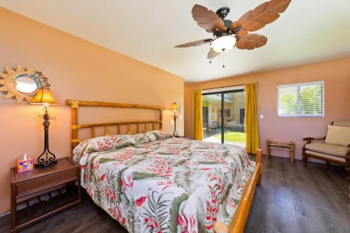 a bedroom with a bed and a ceiling fan at Pu'u Nui in Waikoloa Village