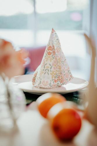 a hat sitting on top of a table with oranges at 4 seasons house in Malmedy
