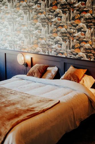 two beds in a bedroom with a large wall at 4 seasons house in Malmedy