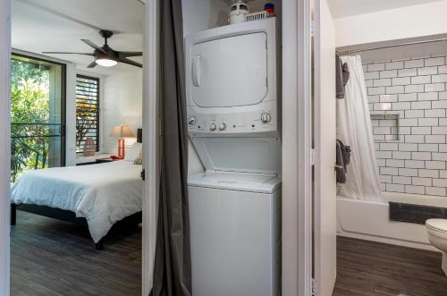 a bedroom with a bed and a tv in a room at Turtle Bay Kuilima Collection 6 West in Kahuku