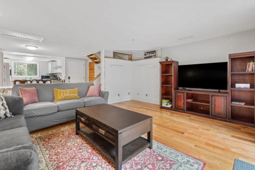 a living room with a couch and a flat screen tv at 2-Bedroom Condo in Thornton in Thornton