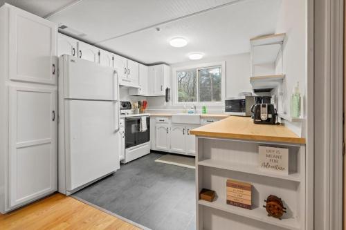 a kitchen with white cabinets and a white refrigerator at 2-Bedroom Condo in Thornton in Thornton