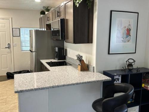 a kitchen with a counter top and a refrigerator at Full House or Studio Suite with Breath Taking Views in Old Bisbee in Bisbee