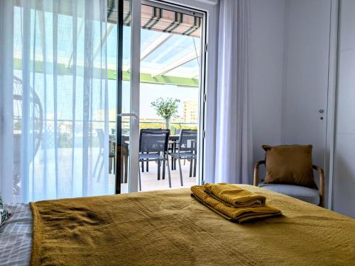 a bedroom with a bed and a view of a patio at Beautiful first line Penthouse with Sea View Mi Capricho in Mijas Costa