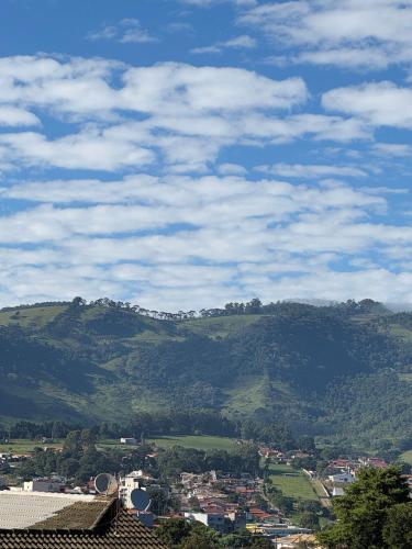 a view of a city with a mountain in the background at Loft Roots in Joanópolis
