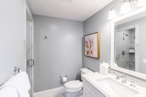 a white bathroom with a sink and a toilet at The Outlook Inn in Newport