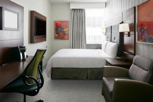 a hotel room with a bed and a couch at Club Quarters Hotel Faneuil Hall, Boston in Boston