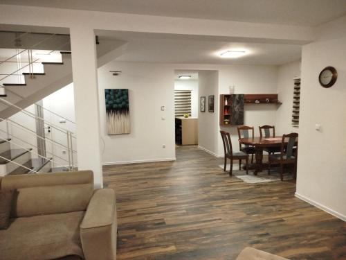a living room and dining room with a table at Villa Orhan in Bihać