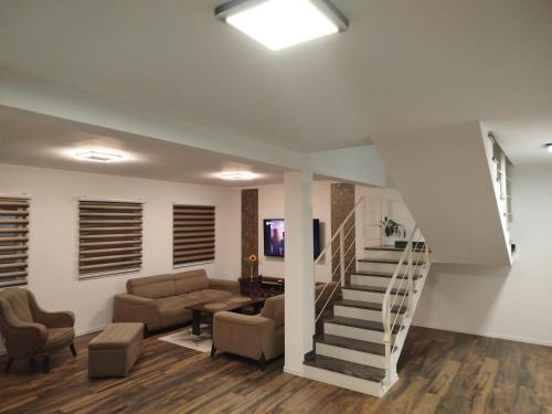 a living room with a staircase and a couch at Villa Orhan in Bihać