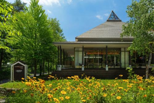 a gazebo with flowers in front of it at Courtyard by Marriott Hakuba in Hakuba