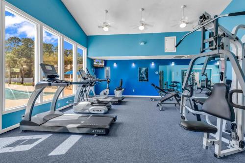 a gym with blue walls and tread machines at The Links in Myrtle Beach