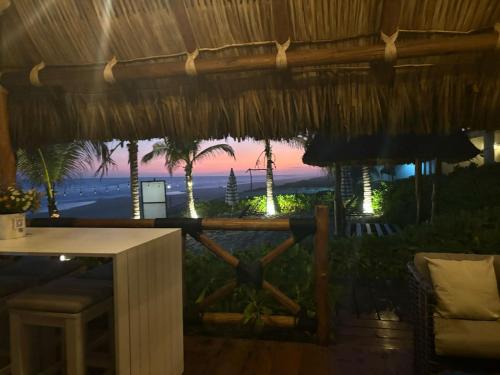a view of the beach from a restaurant with a view of the ocean at Villa Marena Hotel Boutique in Coyuca