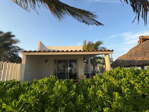 a house with a fence and some bushes at Villa Marena Hotel Boutique in Coyuca