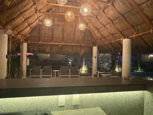 a swimming pool in a resort with chairs and lights at Villa Marena Hotel Boutique in Coyuca