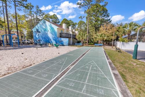 a tennis court on the beach with a building at The Links in Myrtle Beach