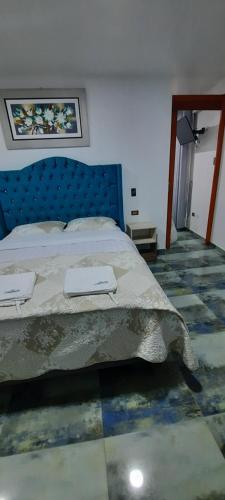 a bedroom with a bed and a tiled floor at La Rinconada de Churin in Churín