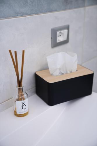 a bedroom with a bed and a vase with sticks in it at ES Rooms and Apartments in Nago-Torbole