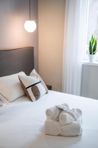 a bedroom with a bed with towels on it at ES Rooms and Apartments in Nago-Torbole