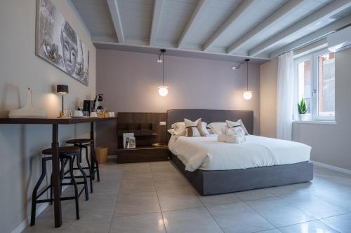 a bedroom with a bed and a bar in it at ES Rooms and Apartments in Nago-Torbole
