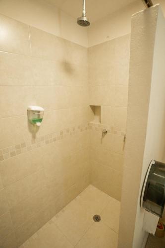 a bathroom with a shower stall with a shower at Gran SAHARA in Playa del Carmen