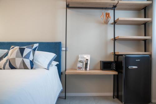 a bedroom with a bunk bed and a black refrigerator at ES Rooms and Apartments in Nago-Torbole
