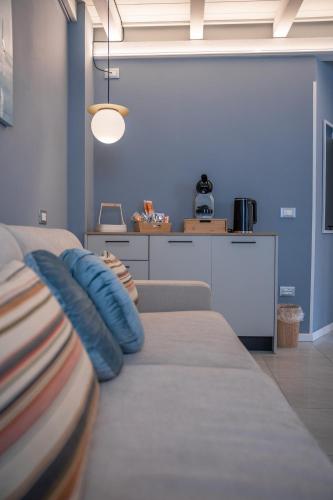 a living room with a couch with pillows on it at ES Rooms and Apartments in Nago-Torbole