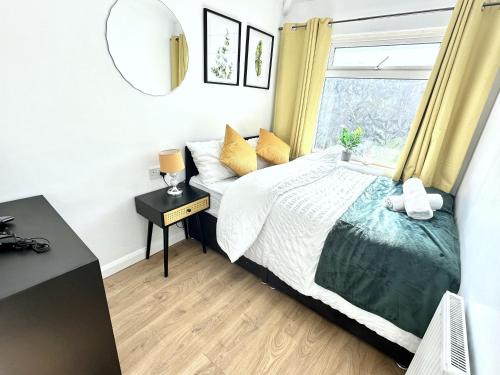 a bedroom with a bed and a window at 3 bedroom entire house sleeps 8 twin beds near Coventry University City Center driveway Parking in Coventry
