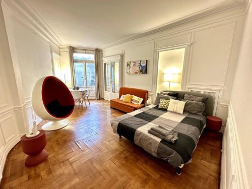 une chambre avec un lit et une chaise dedans dans l'établissement A Luxurious Apartment with AC on Promenade des Anglais, à Nice