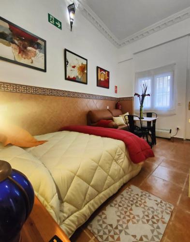 a bedroom with a large bed and a table at Estudio El Santo 1 in Salamanca