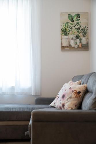 a couch with a pillow on it in a living room at ES Rooms and Apartments in Nago-Torbole