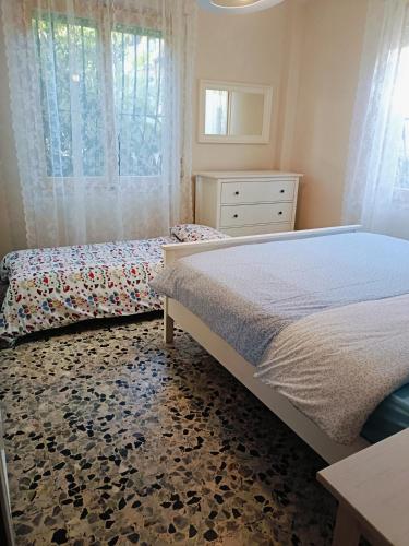 a bedroom with a bed and a dresser at La casa di Piera in Sanremo