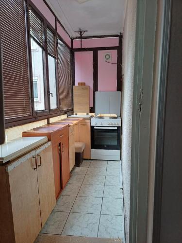 a kitchen with pink walls and a white tile floor at Beautiful house in Smederevo