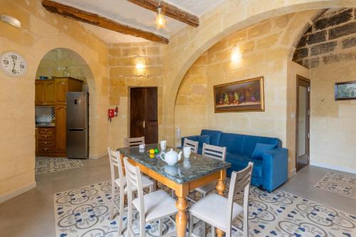 a kitchen and dining room with a table and chairs at Surwig Gozitan Villa & Pool - Happy Rentals in Kerċem