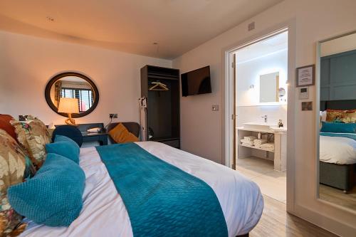 a bedroom with a large bed and a bathroom at The Stables Kersey Mill in Whatfield