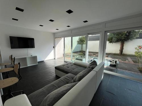 a living room with a couch and a television at Hideaway Leverkusen in Leverkusen