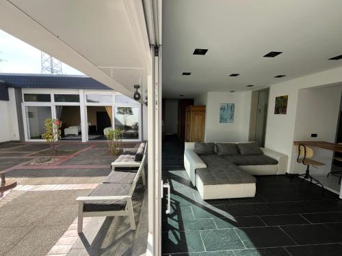 a living room with a couch and a table at Hideaway Leverkusen in Leverkusen