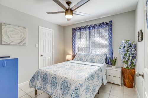 a bedroom with a bed with a blue bedspread and a window at Swim and Unwind Pet-Friendly Home in Spring! in Spring